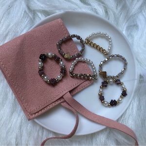 6 gold/silver/purple beaded rings with faux suede mini pouch